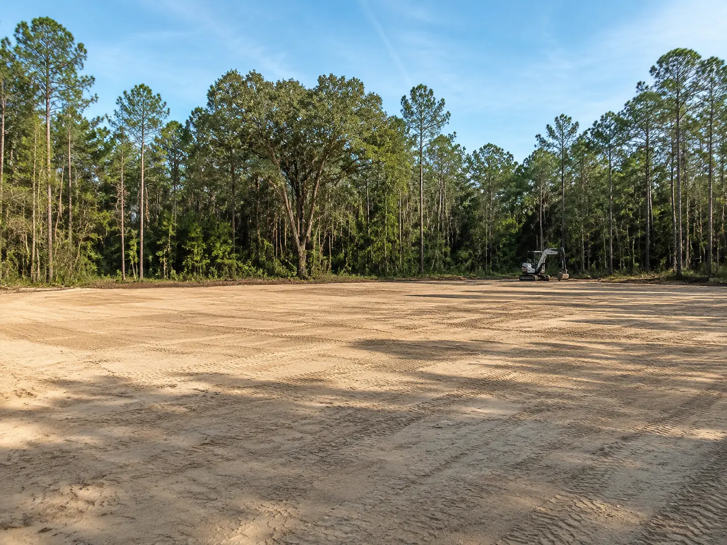 Heavy equipment grading a construction-ready property